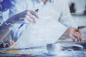 Double exposure of forex graph drawing over people taking notes background. Concept of financial analysis