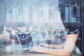 Double exposure of businesswoman hands typing on computer and forex chart hologram drawing. Financial analysis concept.