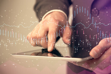Multi exposure of man's hands holding and using a phone and financial chart drawing. Market...