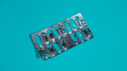 Empty blister on blue background. Medicine concept.