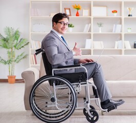 Dsabled businessman on wheelchair working home