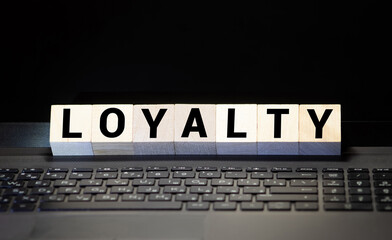 Modern business buzzword - loyalty. Word on wooden blocks on a white background.