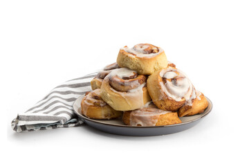 a heaping plate of freshly iced refrigerator cinnamon buns isolated on white