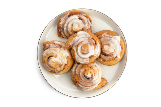 Overhead View Of A Plate Full Of Fresh Cinnamon Buns Isolated On White