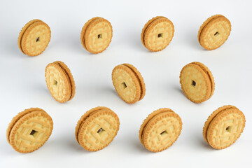 Rows of cookies stand on a white clipping background. Close-up photographed.