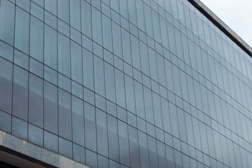 Blue modern windows building patter reflecting sky. 