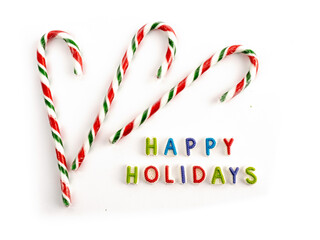 Happy Holidays greeting text spelled in colorful candy letters isolated on white

