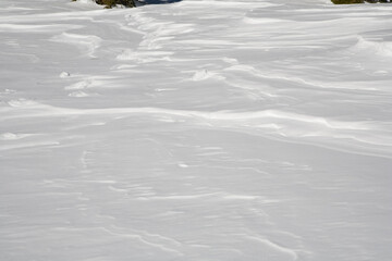 close up of fresh, white, hard-pack snow with wind lines and shadows