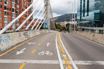 BOGOTA, COLOMBIA -  A bike way over a vehicular bridge near to a moder building and residential...