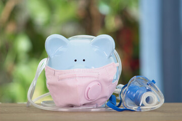 Piggy piggy bank wearing a mask and atomization tool