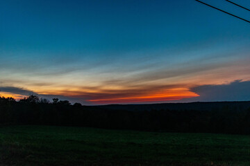 sunset in the mountains over the field