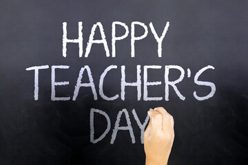 Obraz premium Little girl hand writes text of happy teachers day