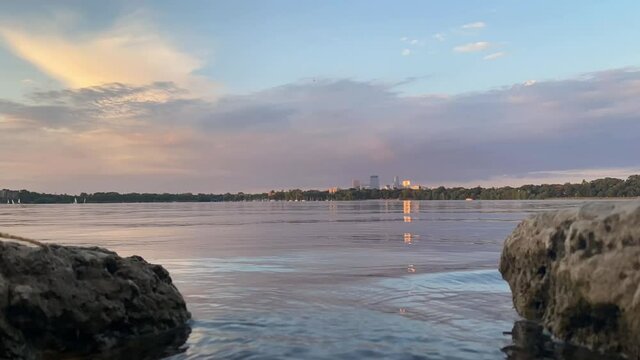 time lapse over lake in minneapolis, down town minneapolis seen in the distance