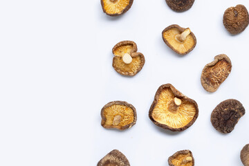 Dried shiitake mushrooms on white background.