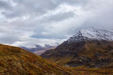 View of Scenic Landscape and Mountains in Canadian Nature. Season change from Fall to Winter. Taken near Grizzly Lake in Tombstone Territorial Park, Yukon, Canada.