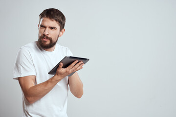 emotional man with tablet in hand touch screen new technologies light background cropped view Copy Space