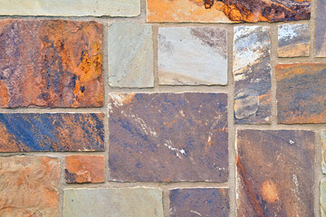 Various colors of brick in wall.  background, brown and rust colored bricks.  
