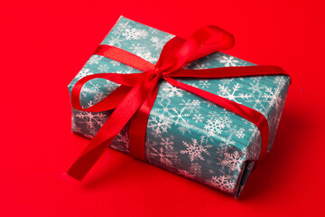 christmas gift in box on red background.