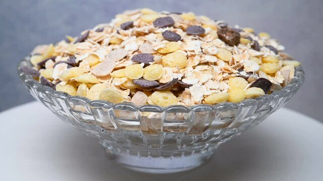 side view glass bowl of mixed oatmeal and maize and dark grains and red jujube and coix seed rotating