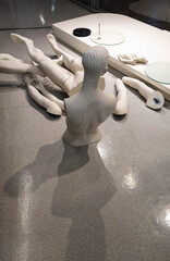 White disassembled manikin consisting of arms and legs
