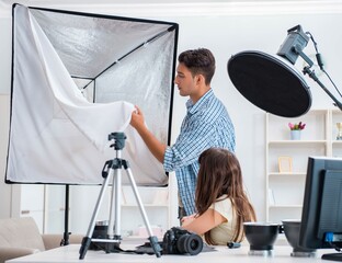 Young photographer working in photo studio