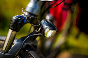 Bicycle light close-up on a blurry green background