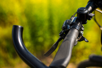 Fototapeta na wymiar Bicycle handlebar close-up on a green background