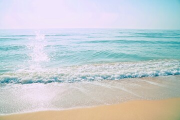 Fototapeta na wymiar Emerald color of sea water on beach in morning light. Beautiful nature background.