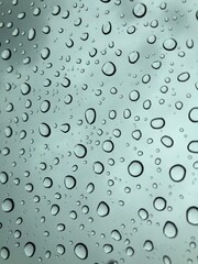 Image of water droplets on a clear glass surface during heavy rain.
