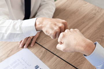 Colleagues Achievement Business Casual Fist bump together after dealing mission business, Business success and teamwork concept