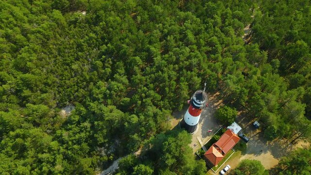 The drone slow spin around Stilo Lighthouse - lighthouse located in Osetnik on the Polish coast of the Baltic Sea, close to the village of Sasino, aerial daytime 