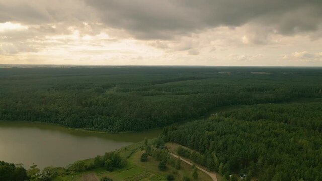 Okierskie lake, and dense green deciduous forests of Kowalskie Blota village, district of Gmina Cekcyn, Kuyavian-Pomeranian Voivodeship, in north-central Poland, pan motion, Aerial 