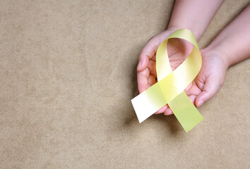 hands holding yellow ribbon With copy space.