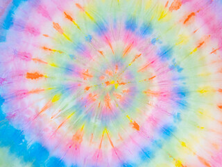 Rainbow spiral tie dye background pattern. Swirl hippie tiedye wallpaper. Boho festive tie-dye backdrop.