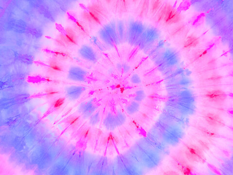 Spiral tie dye wallpaper. Hippie tie-dye background. Tiedye backdrop. Psychedelic tie dye pattern in pink purple. 