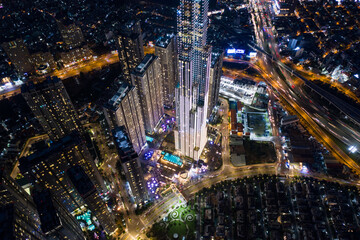 Aerial urban colorful sunrise panorama with high rise building disappearing into the clouds, city center skyline and suburban sprawl