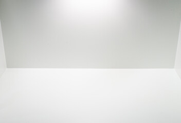 Image of a white scene with empty space with light and shadow.