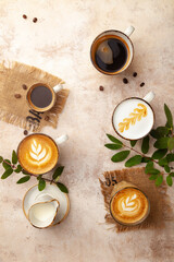 Obraz na płótnie Canvas Latte, espresso, cappuccino coffee cups on beige vintage pastel background