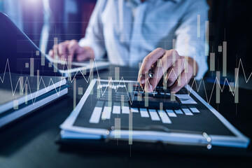 Concept of research. Financial forex graph displayed on hands taking notes computer laptop, smartphone, and tablet at office.