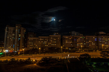 Night view on the buildings of Vladivostok with a full moon shining above 