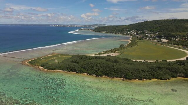 Drone panning down over Asan Point and the coral of Guam