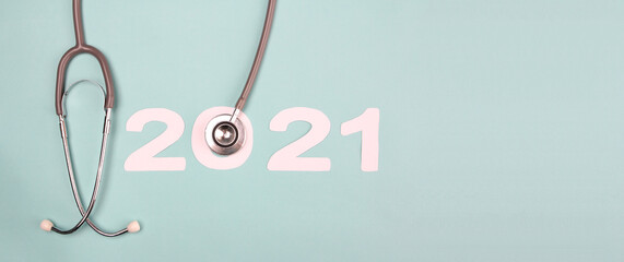 2021 number with stethoscope on blue background. Concept Happy New Year 2021,concept health and...