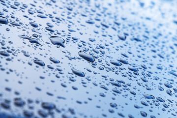 Water droplets are on shiny metal surface, background