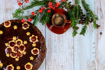 Chocolate rum cake with coffee on wooden background.