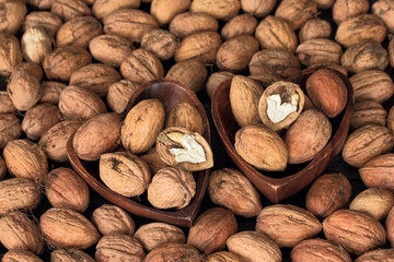 walnuts in wooden bowls close-up. background with walnuts. texture with walnuts.
