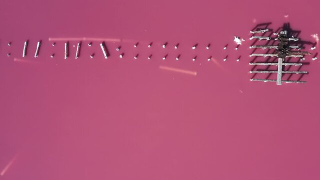 Gorgeous rising aerial view over a boardwalk at high-tide in the pink lake in Sasyk-Sivash, Crimea.