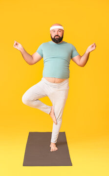 Overweight Man Practicing Yoga On Color Background. Weight Loss Concept