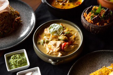 Sri lankan dishes on restaurant table setting.