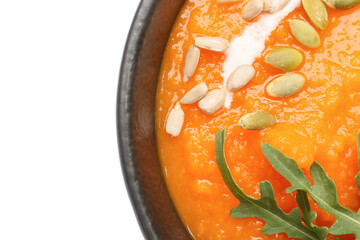 Tasty pumpkin cream soup in bowl on white background, closeup