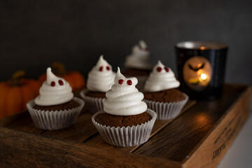 Halloween ghost cupcakes , homemade sweet chocolate muffins with meringue ghost